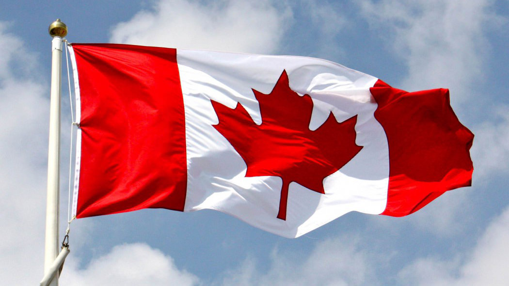 Canadian flag blowing in the wind - CRTC honour Canadian communications trailblazers