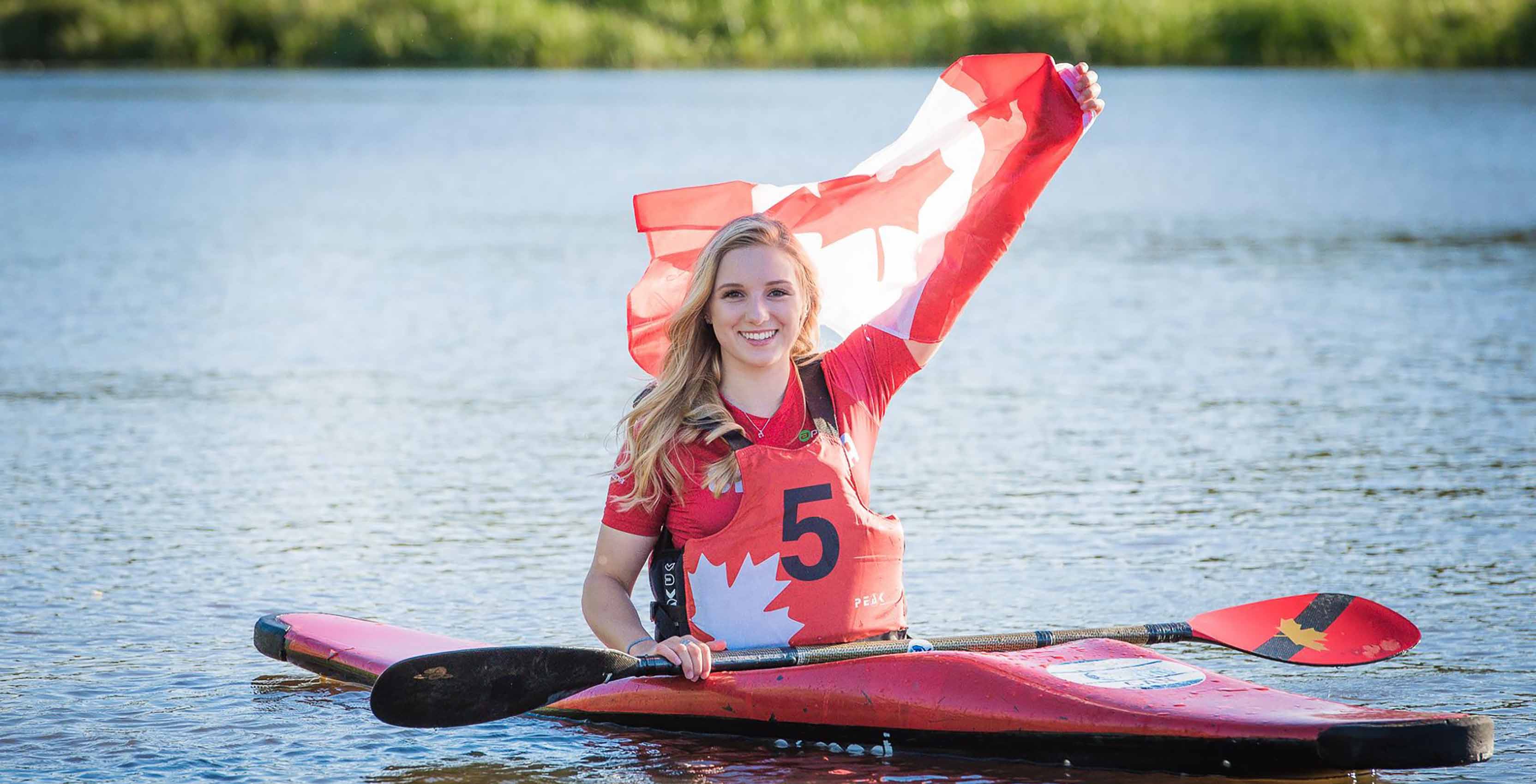 woman with Canadian flag in kayak