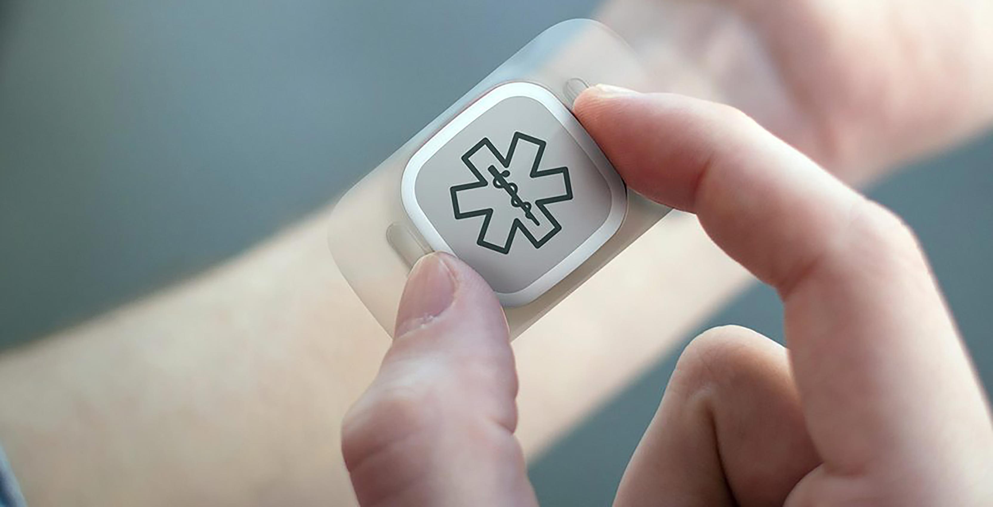 Wearable in hand with medical symbol