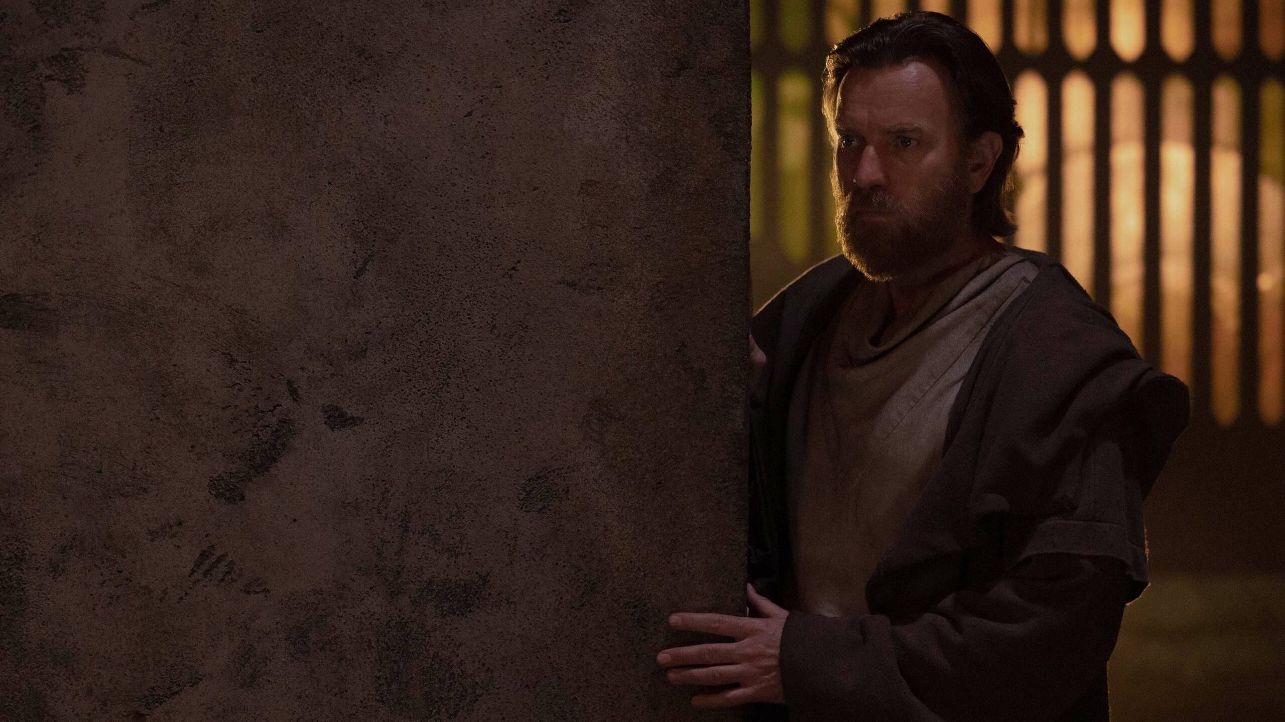 Ewan McGregor in the Obi-Wan Kenobi TV series watching from behind a corner